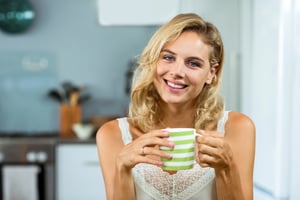 happy-young-woman-having-coffee-home